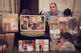 A person sitting down behind six paintings