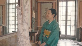 Setsuko standing in front of one of her decorative ceramic pieces in the Musée national des châteaux de Malmaison et Bois-Préau, Rueil-Malmaison, France